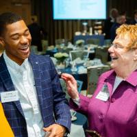 Lynn "Chick" Blue laughing while talking to Lavar Green-Jackson